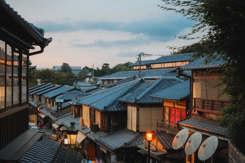 A serene evening scene capturing traditional rooftops in the historic Higashiyama district, Kyoto, Japan.