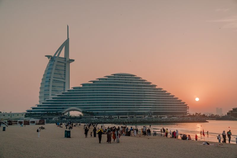 Capture of the Burj Al Arab and Jumeirah Beach during a breathtaking sunset in Dubai.