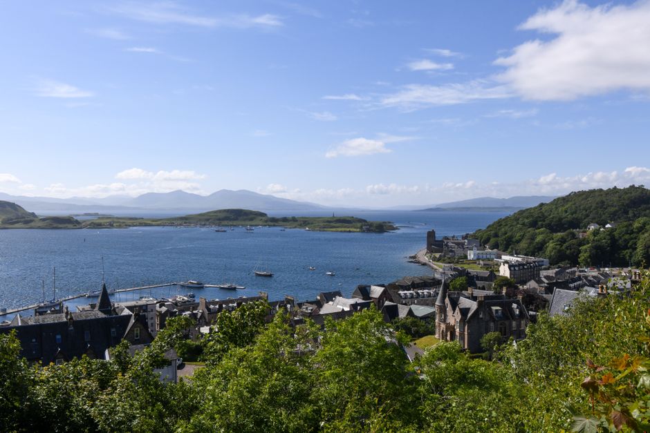 Stunning summer view of Oban Bay and the surrounding landscape in Scotland.