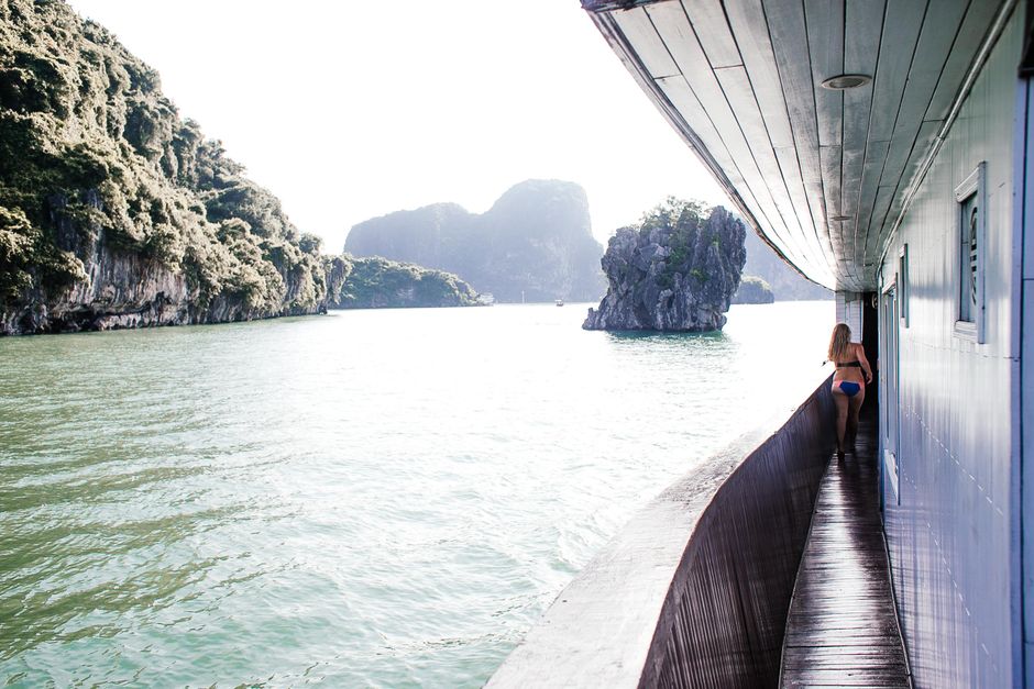 A woman enjoys a scenic cruise on a ship in Ha Long Bay, Vietnam.